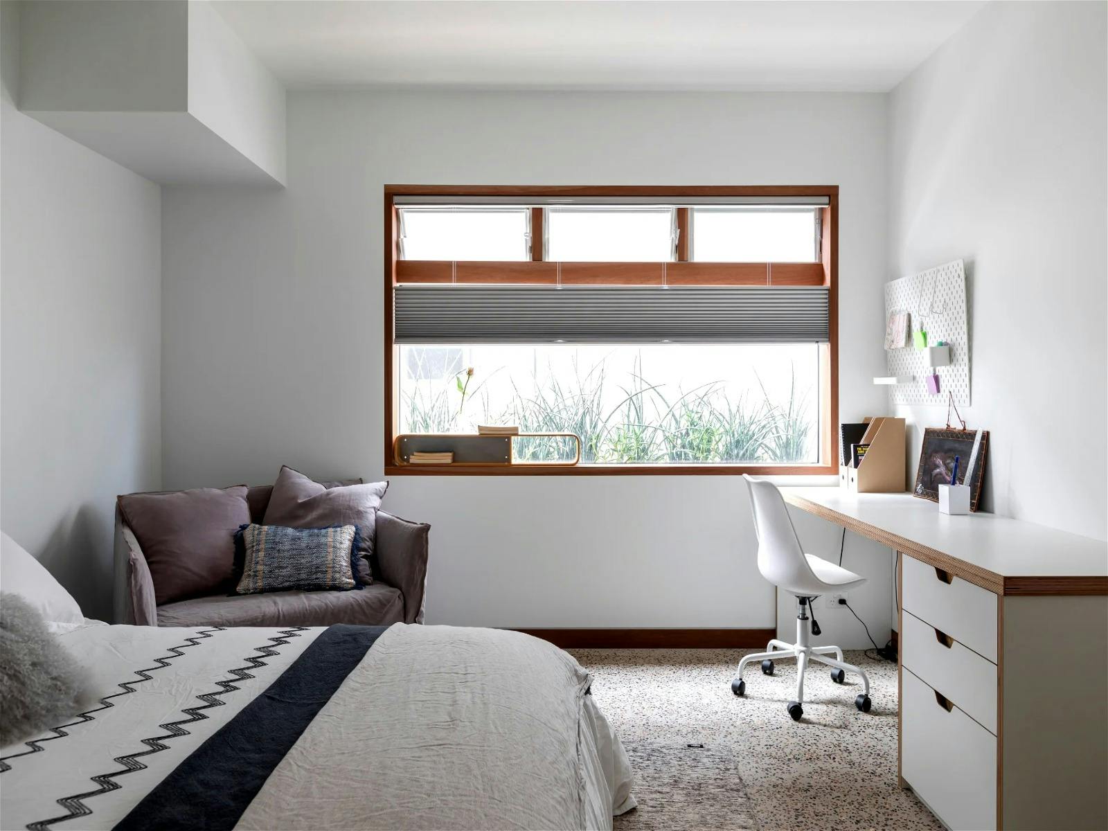 Modern minimalist bedroom with sleek furniture and neutral color palette