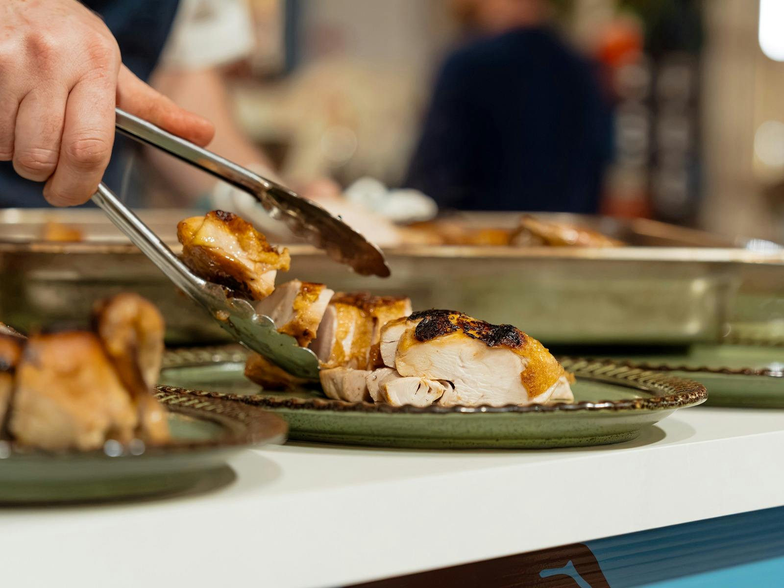 Roasted chicken being plated for the Barossa Farmers Market Long Lunch.