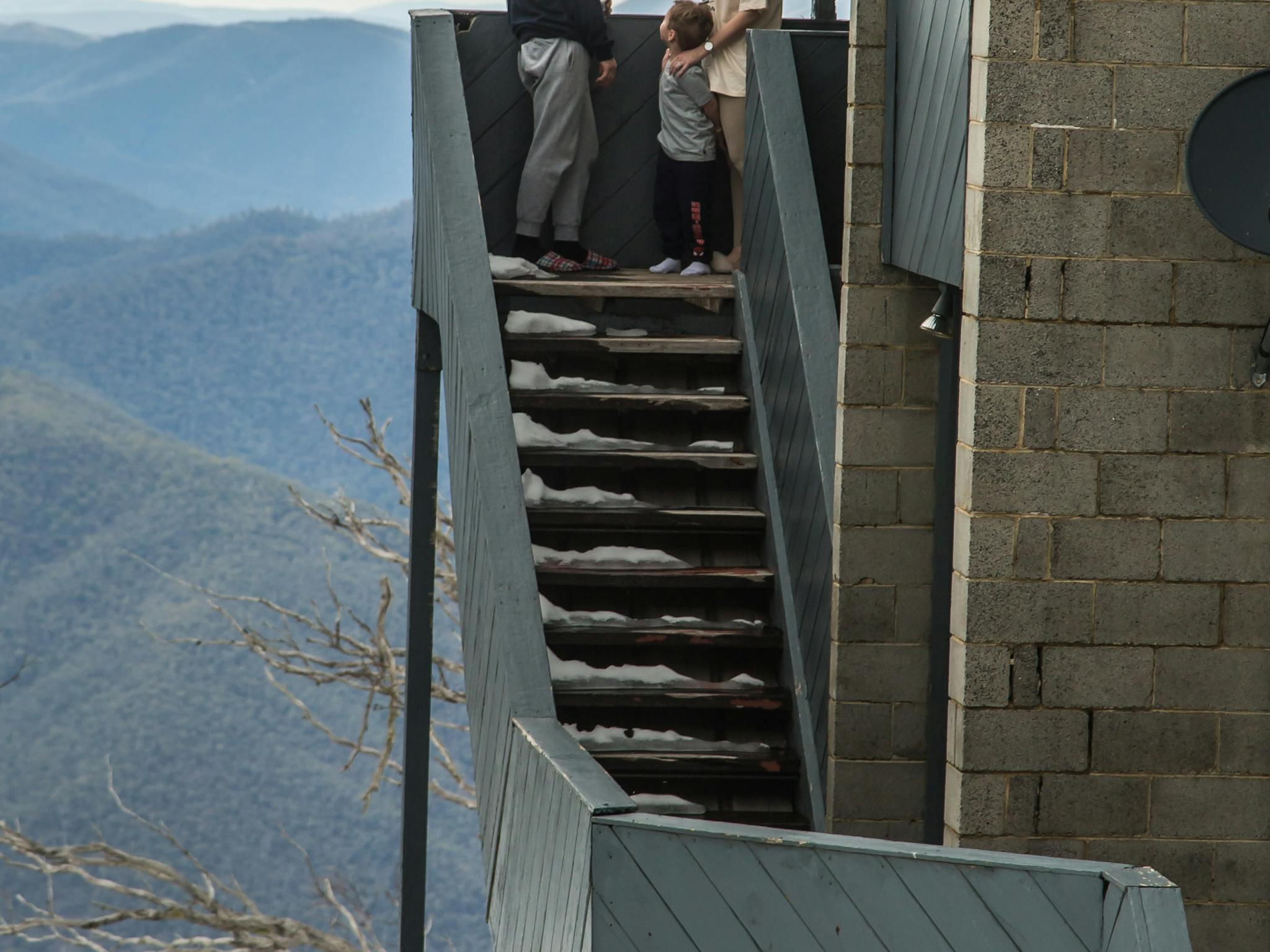 Young family enjoying the view from the top floor over Victoria's High Country