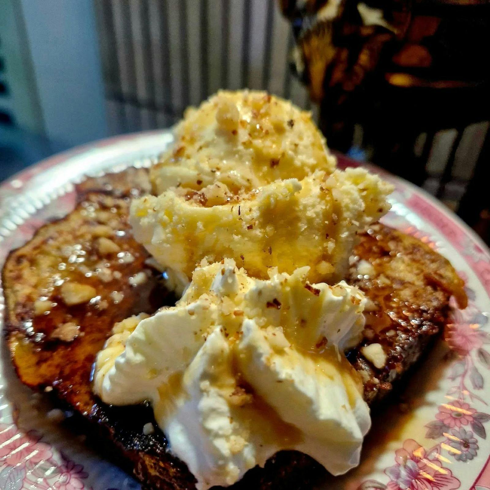 Fluffy whipped cream on waffles, sprinkled with chopped nuts
