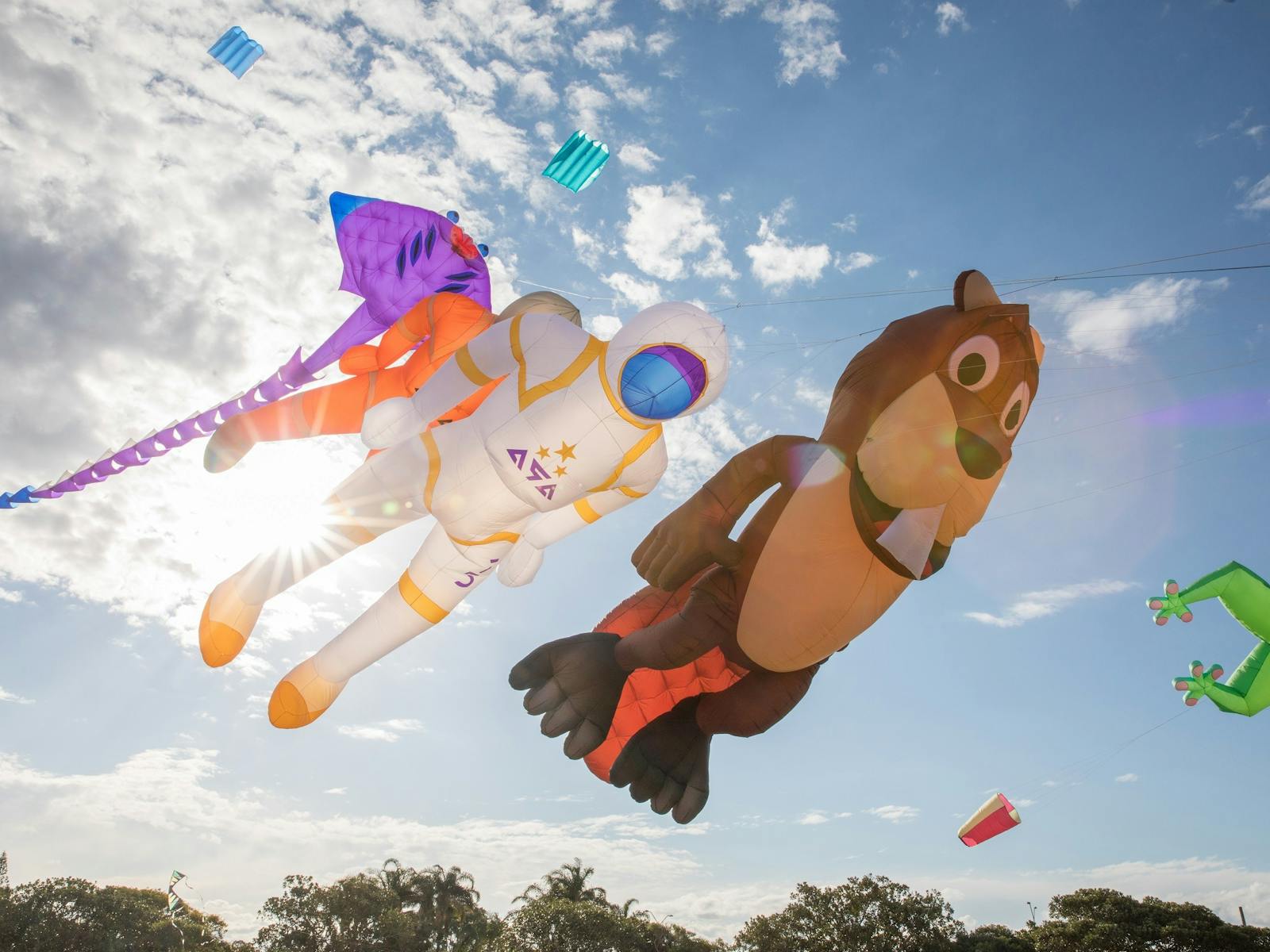 Large bear, astronaut and sting ray kites flying in the sky Large bear, astronaut and sting ray kites flying in the sky