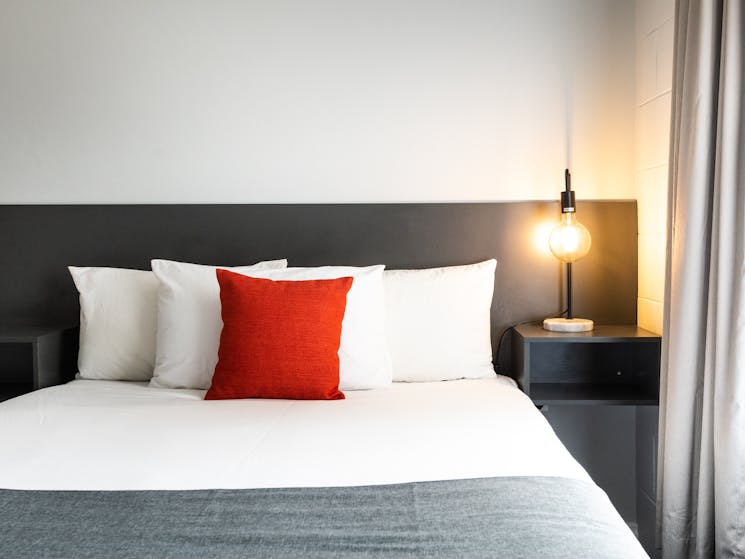 Modern styling and comfortable bedding at River Motel.