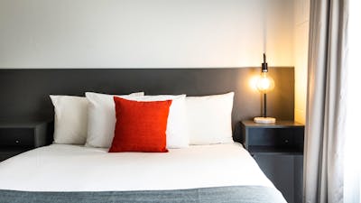 Modern styling and comfortable bedding at River Motel.