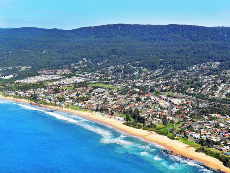 Beach with suburbs and mountain in background