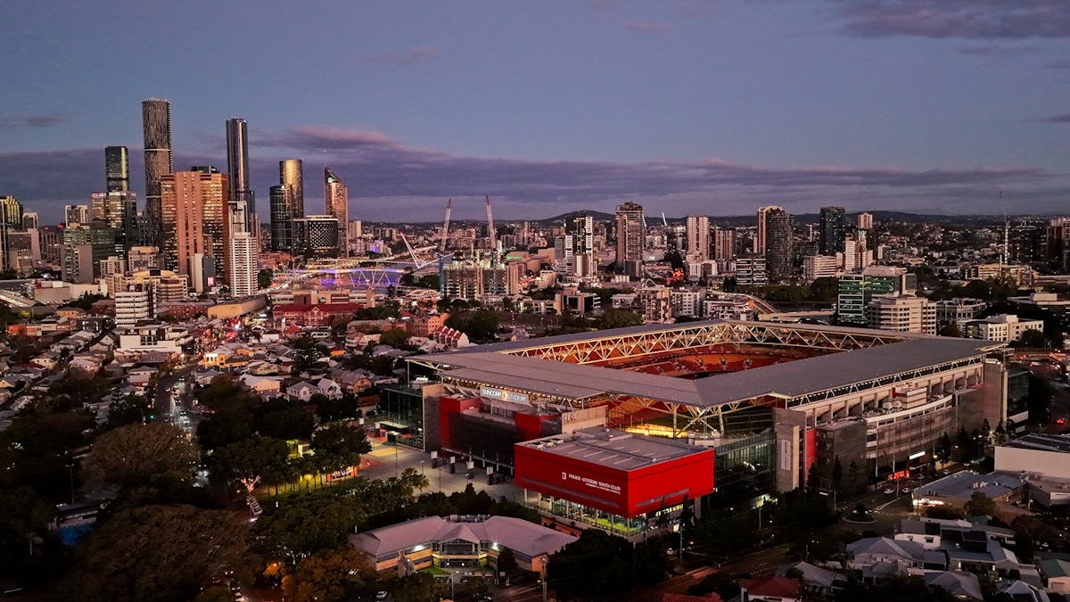 Aerial shot of Suncorp Stadium in the evening with the city in the background