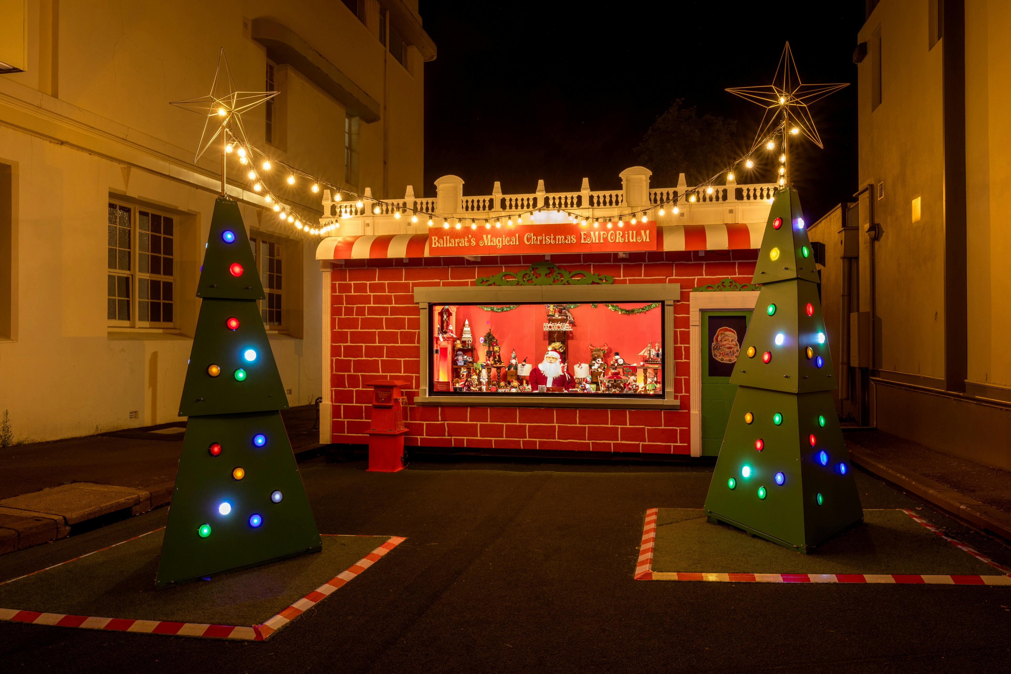 The Magical Christmas Emporium and Christmas Trees are lit up at night