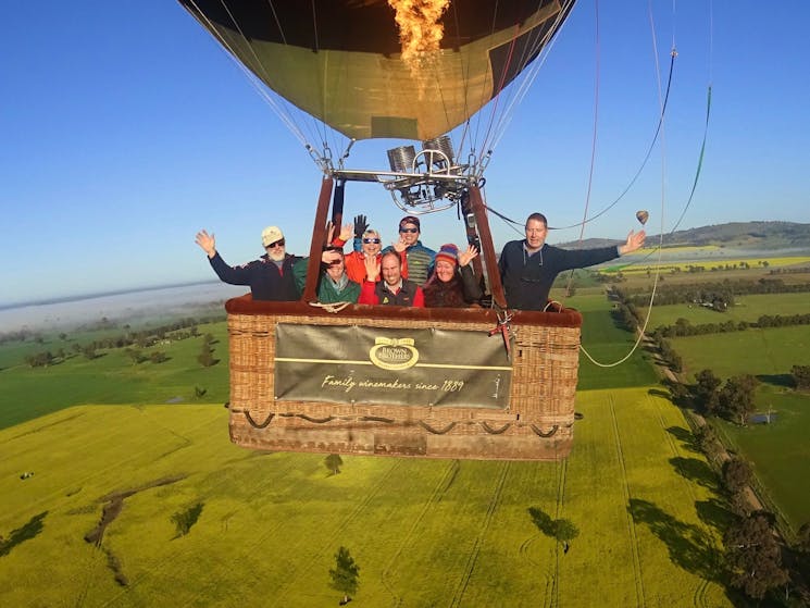 Basket of guests aloft over canola