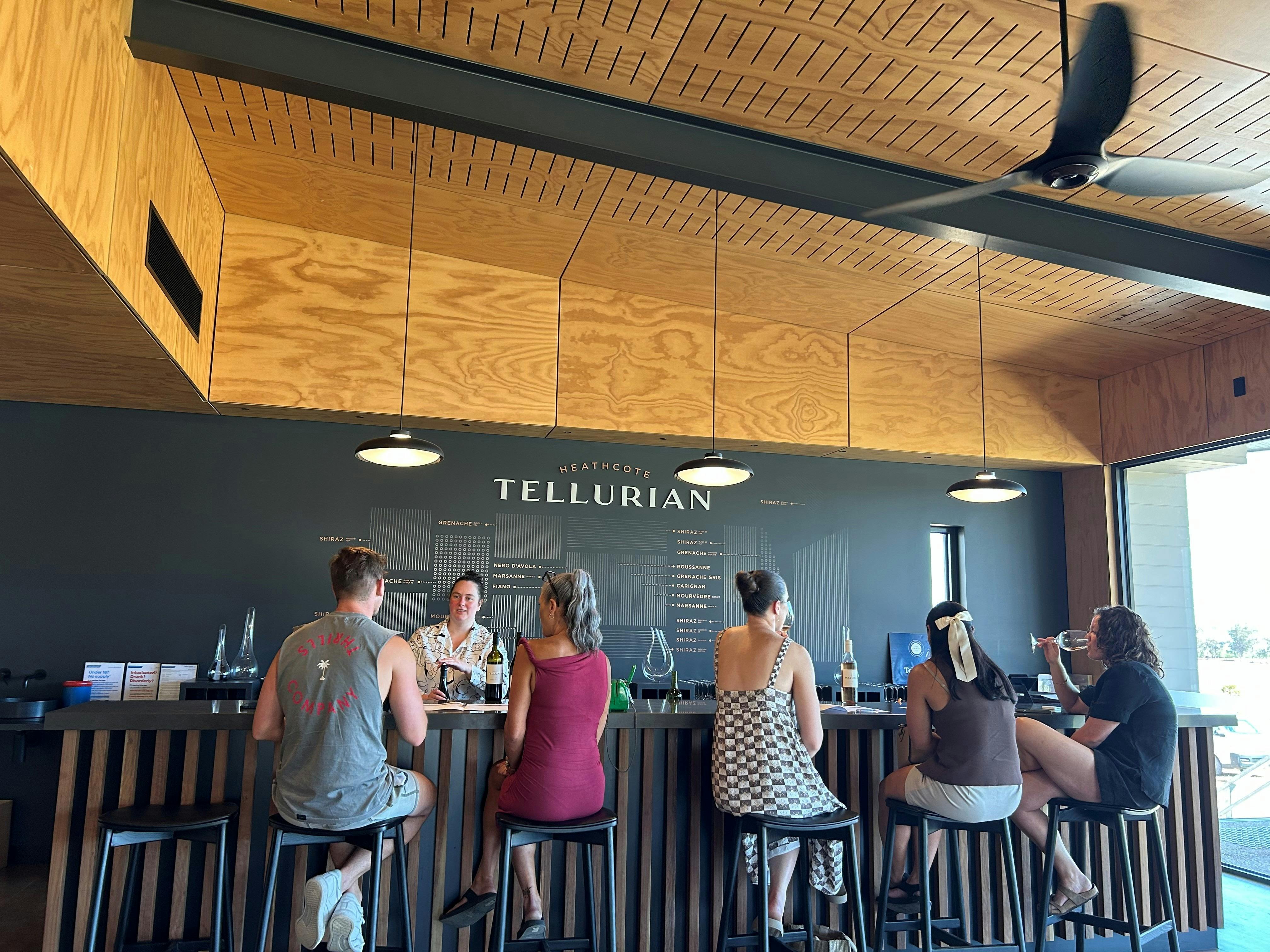 People sitting at a bar doing a wine tasting