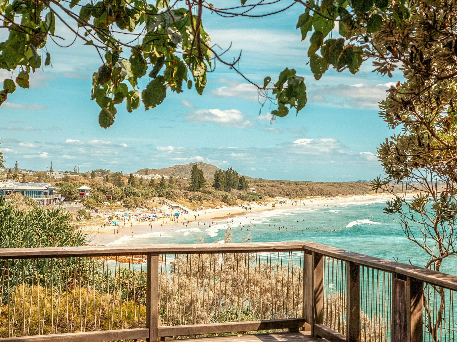 Looking north from the Coolum Beach boardwalk, with swimmers in the distance.