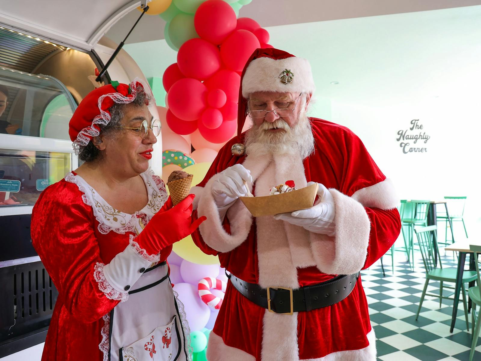 Santa and Mrs Claus enjoying treats in The Naughty Corner