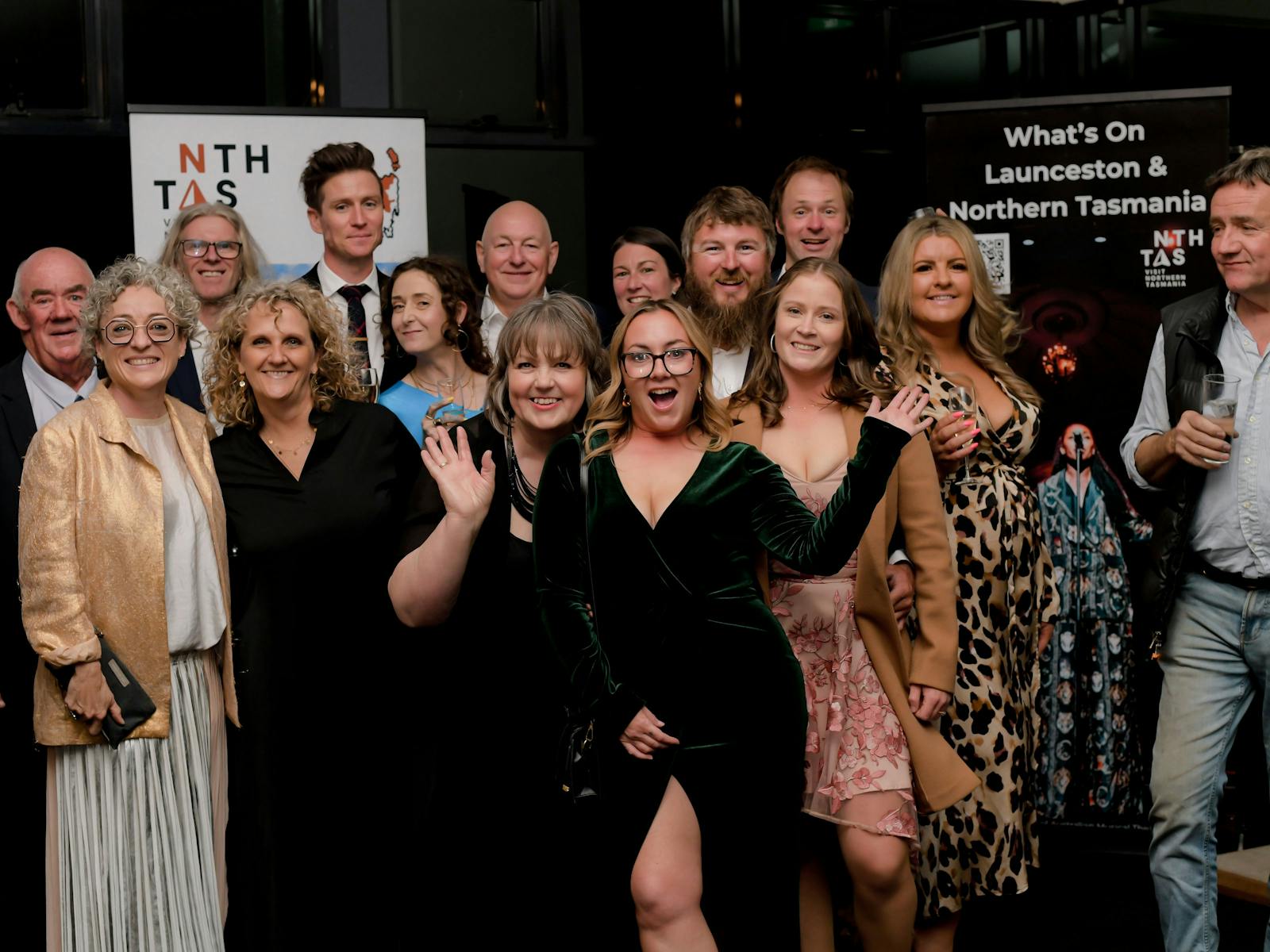 A group of snazzily dressed tourism and hospitality experts smiling at the camer.