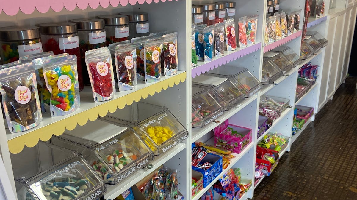 Interior shelves displaying packaged lollies and sweets inside Sugar Rush Dayboro in Dayboro, Queens