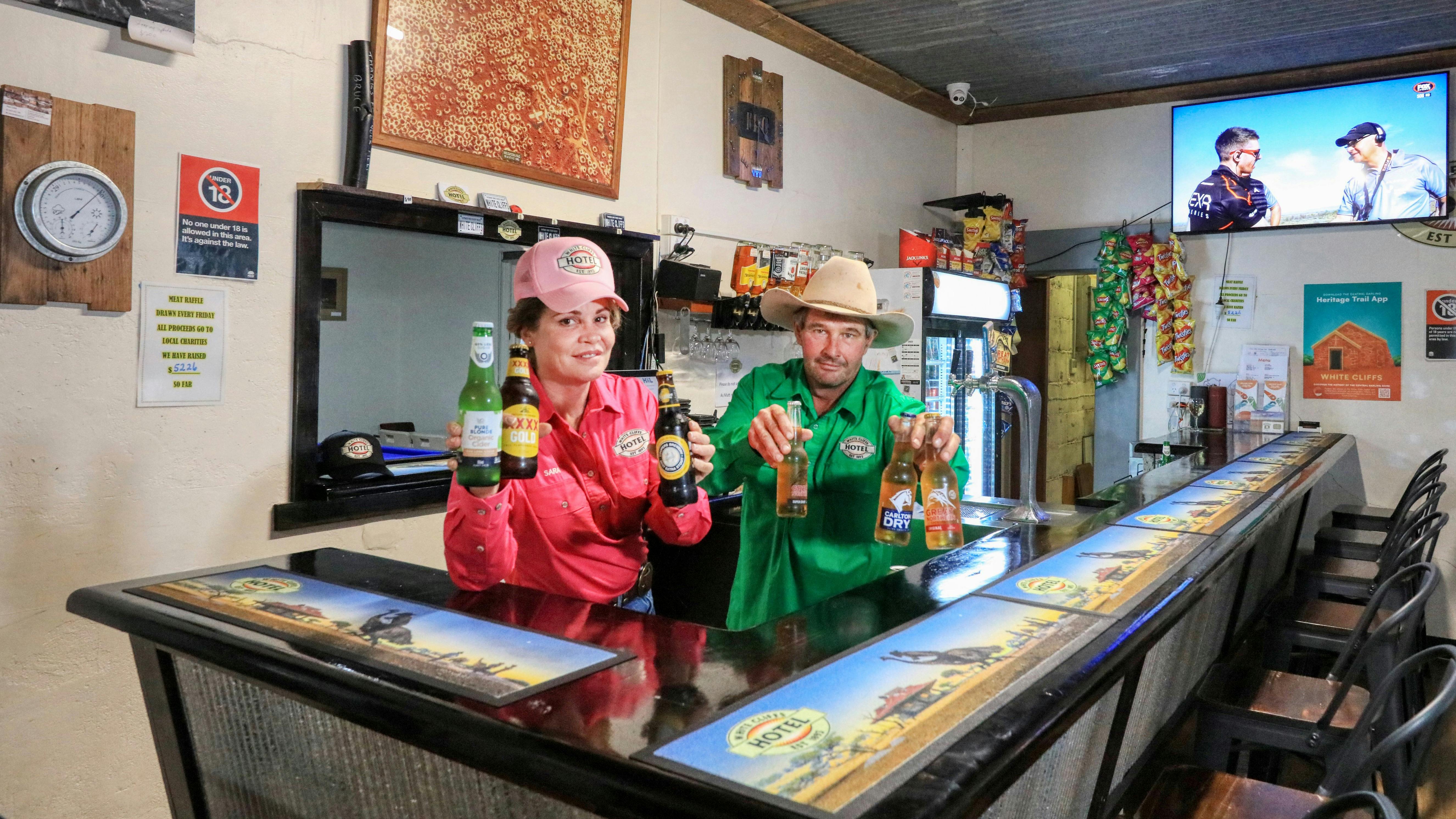 Hotel staff in the front bar holding lovely cold beverages