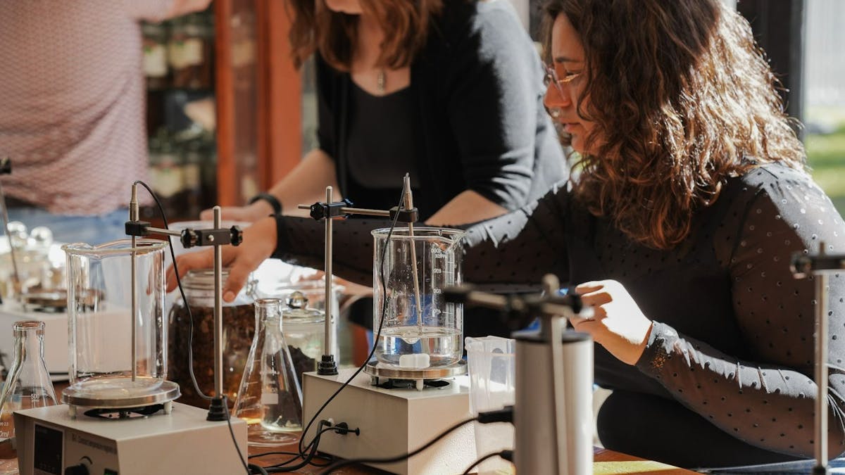 Woman working at a table during the spirit blending experience. Woman working at a table during the spirit blending experience.
