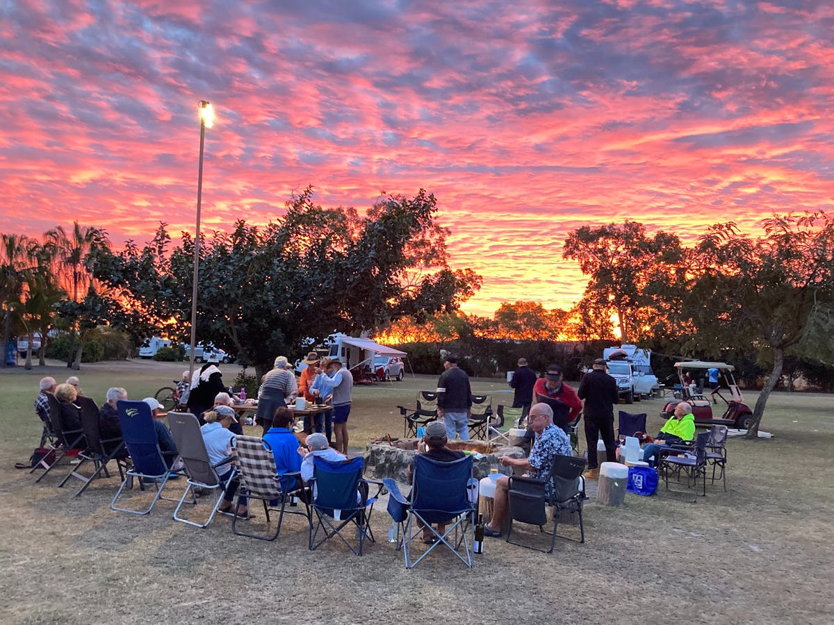Jaffle Night with friends enjoying a chat whilst in the background are pinks and blues of sunset