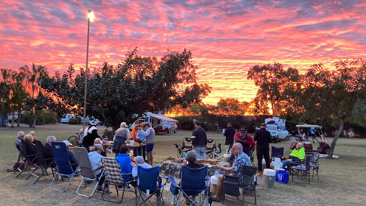 Jaffle Night with friends enjoying a chat whilst in the background are pinks and blues of sunset