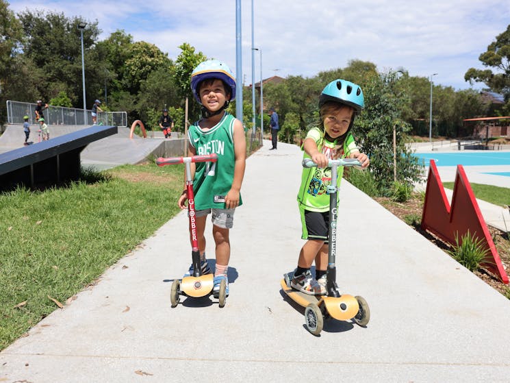 Children ridign scooters at Olds Park