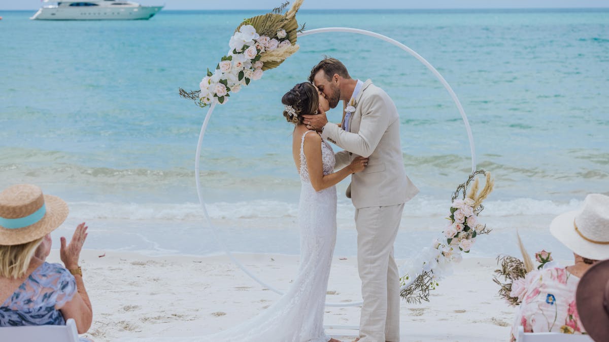 Couple Kissing Wedding Whitehaven Beach Round Wedding Arbour