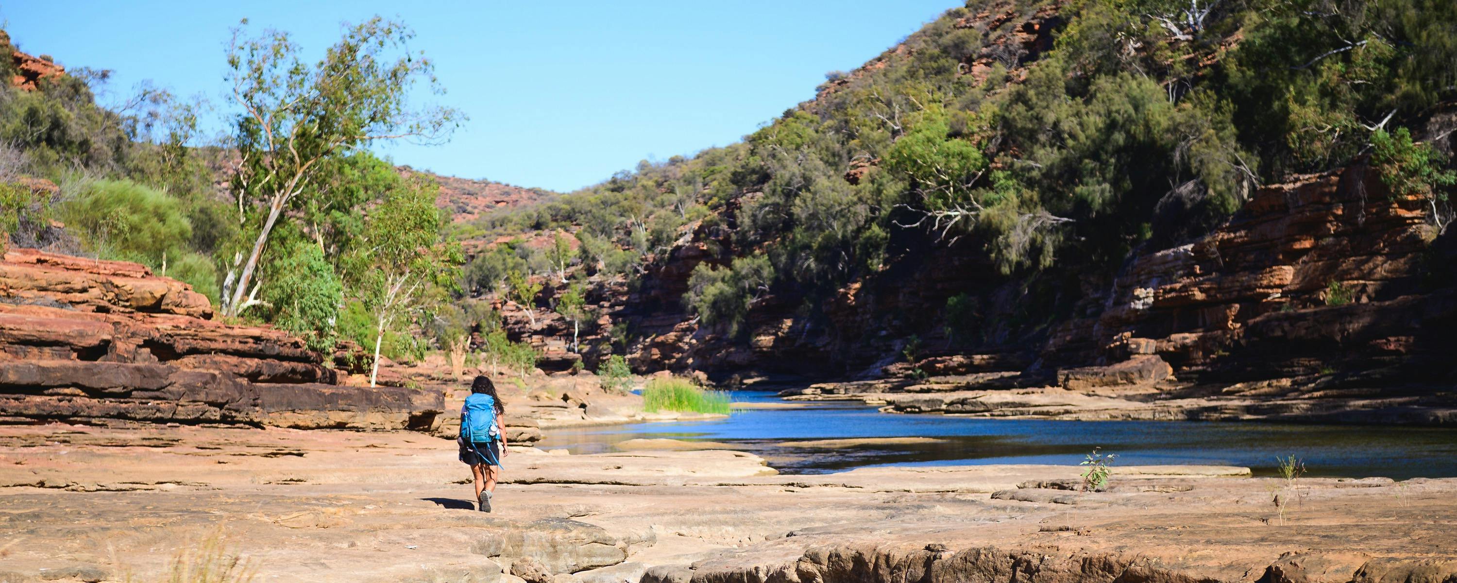 Woman walking along the Murchison Gorge - the river is in the background