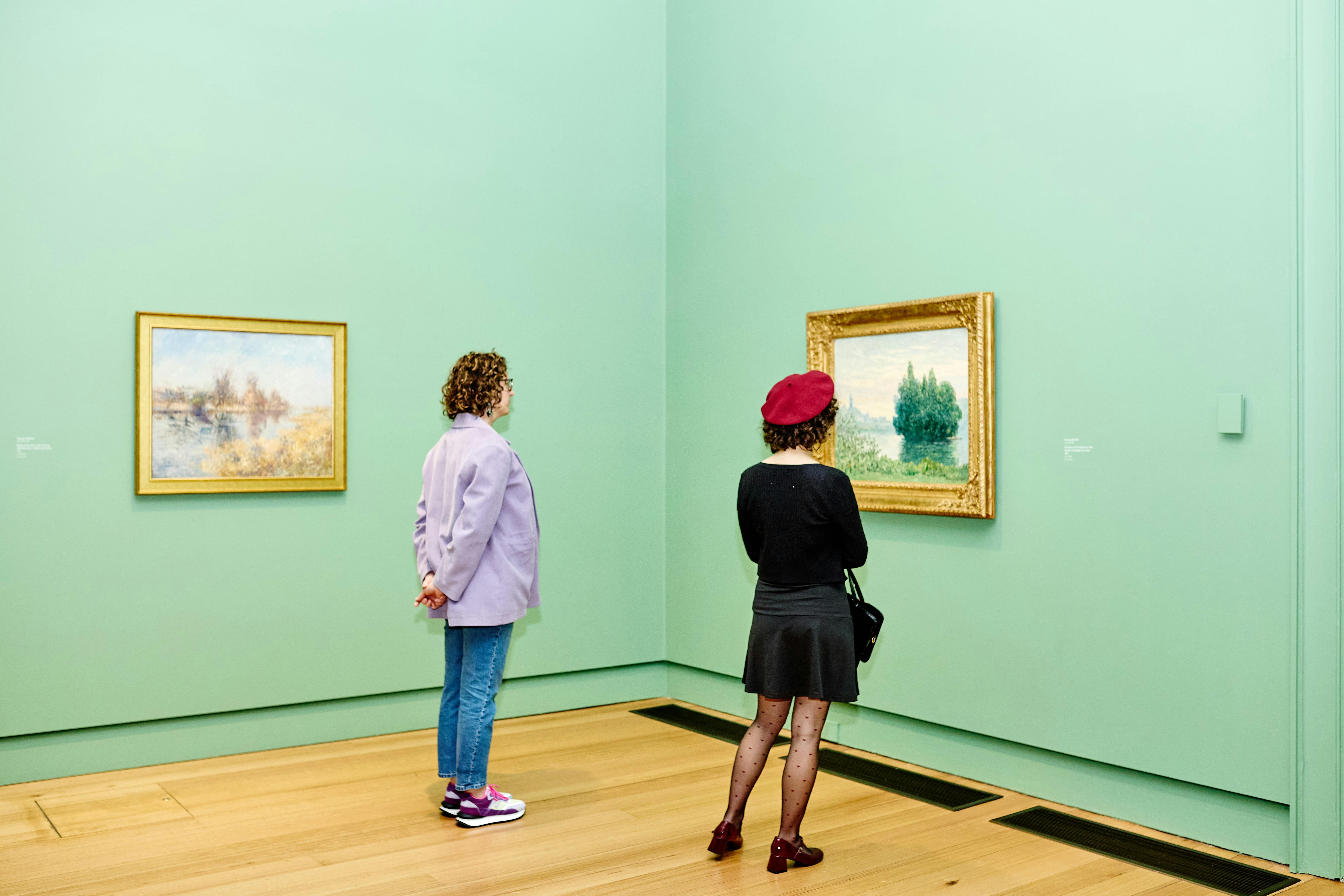 two visitors looking at an Impressionist artwork in gallery