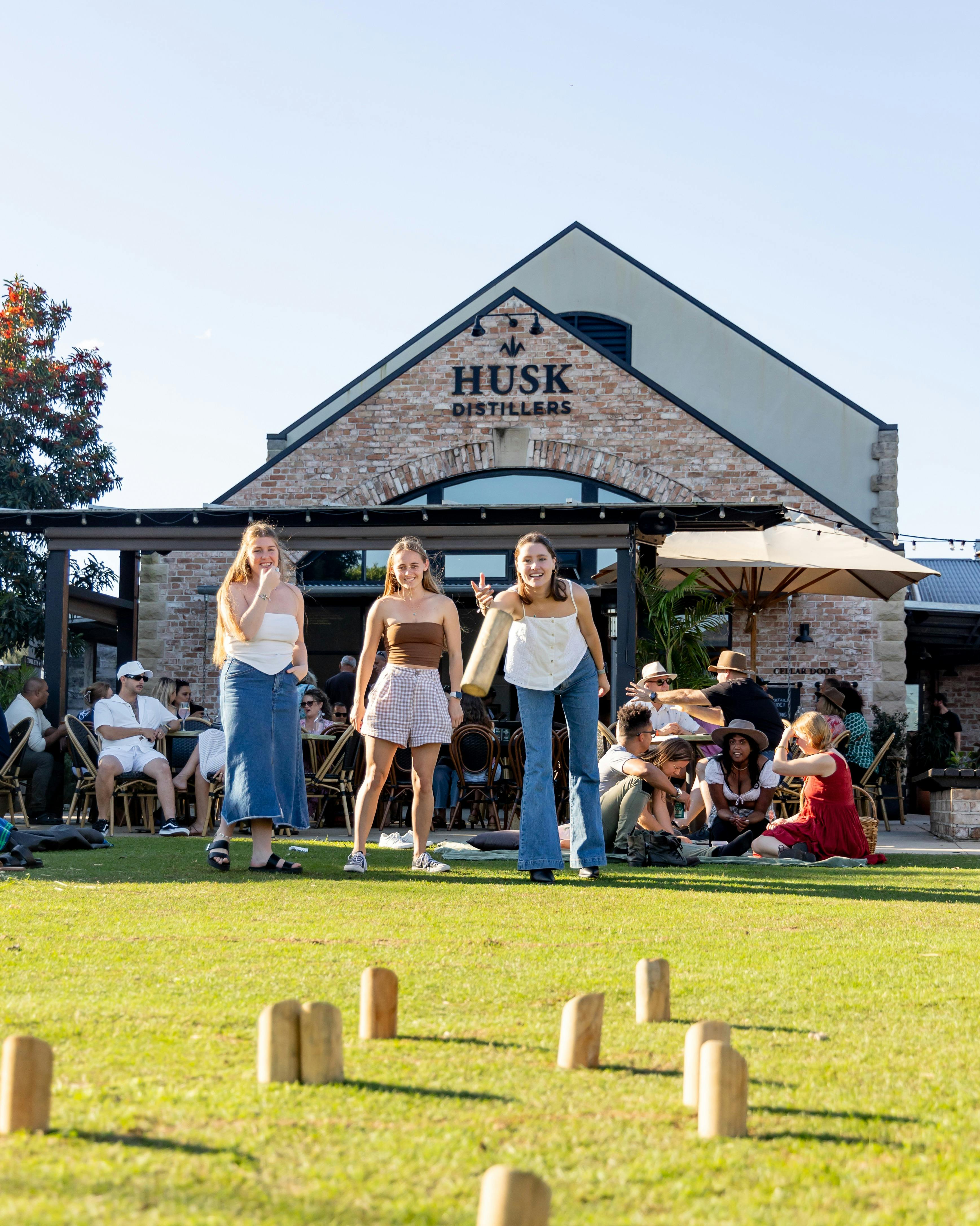 Guests playing lawn games at Husk Farm Distillery.