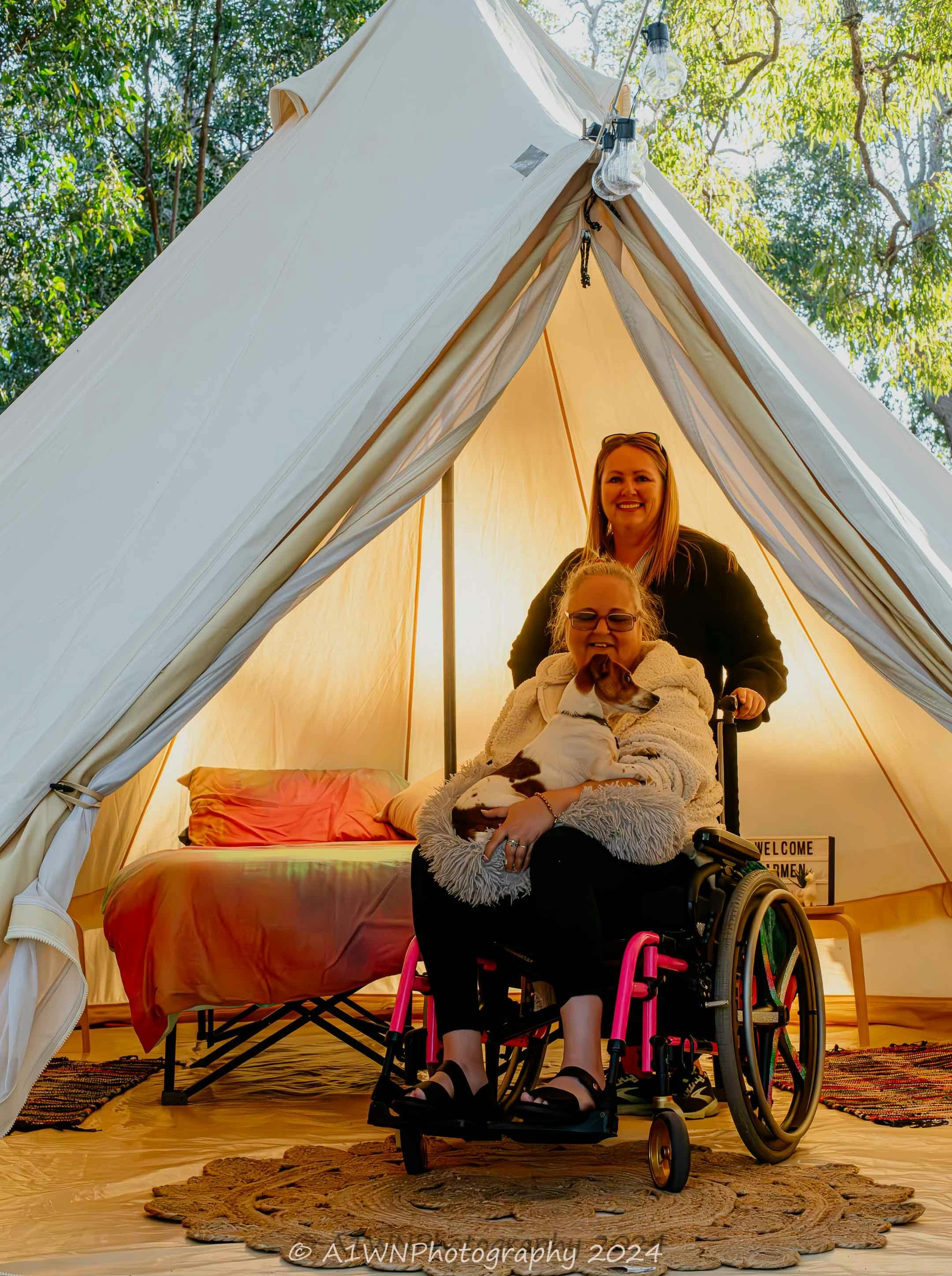 Bell tent showing the accessibility option with a raised bed on a stretcher