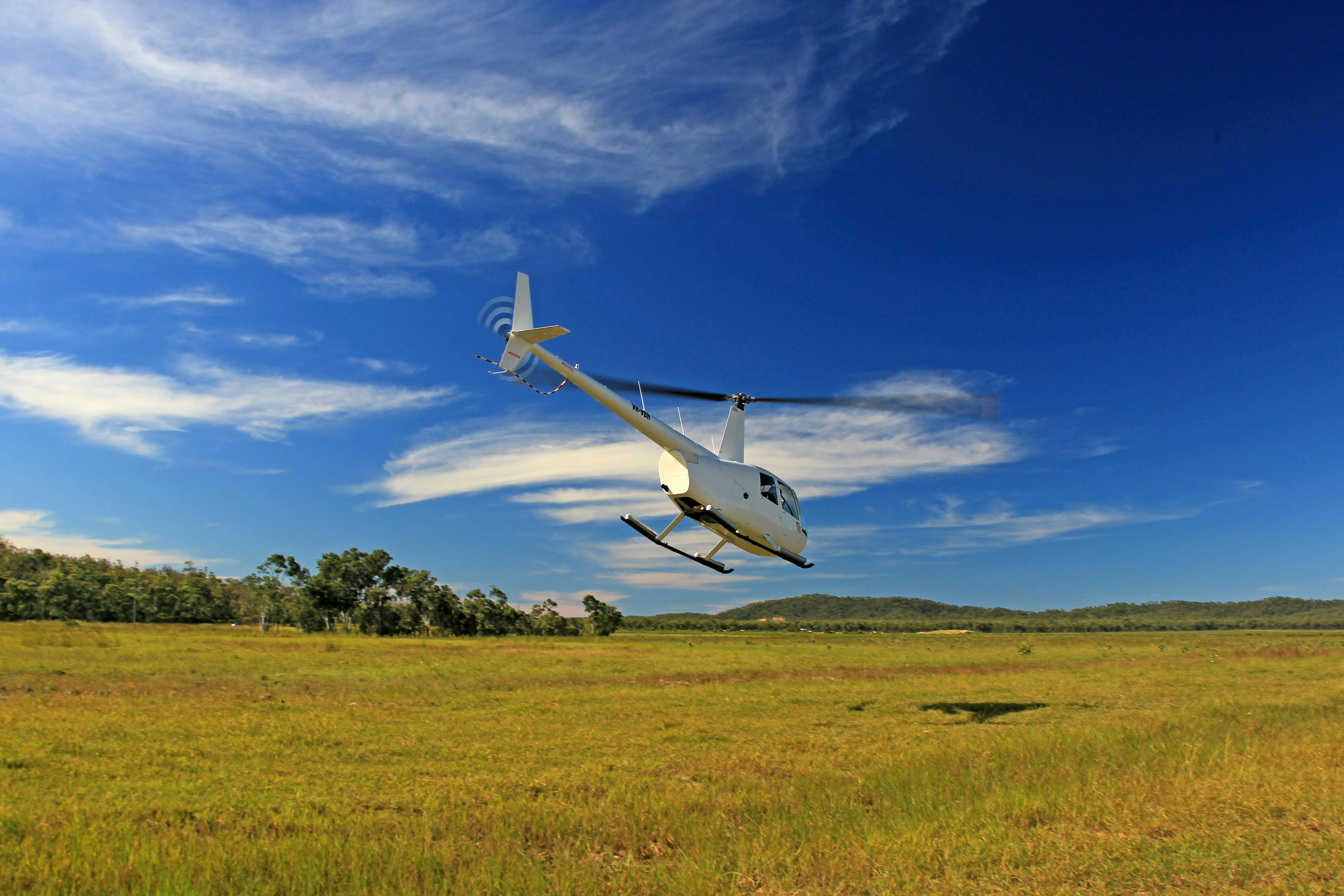helicopter flying over field