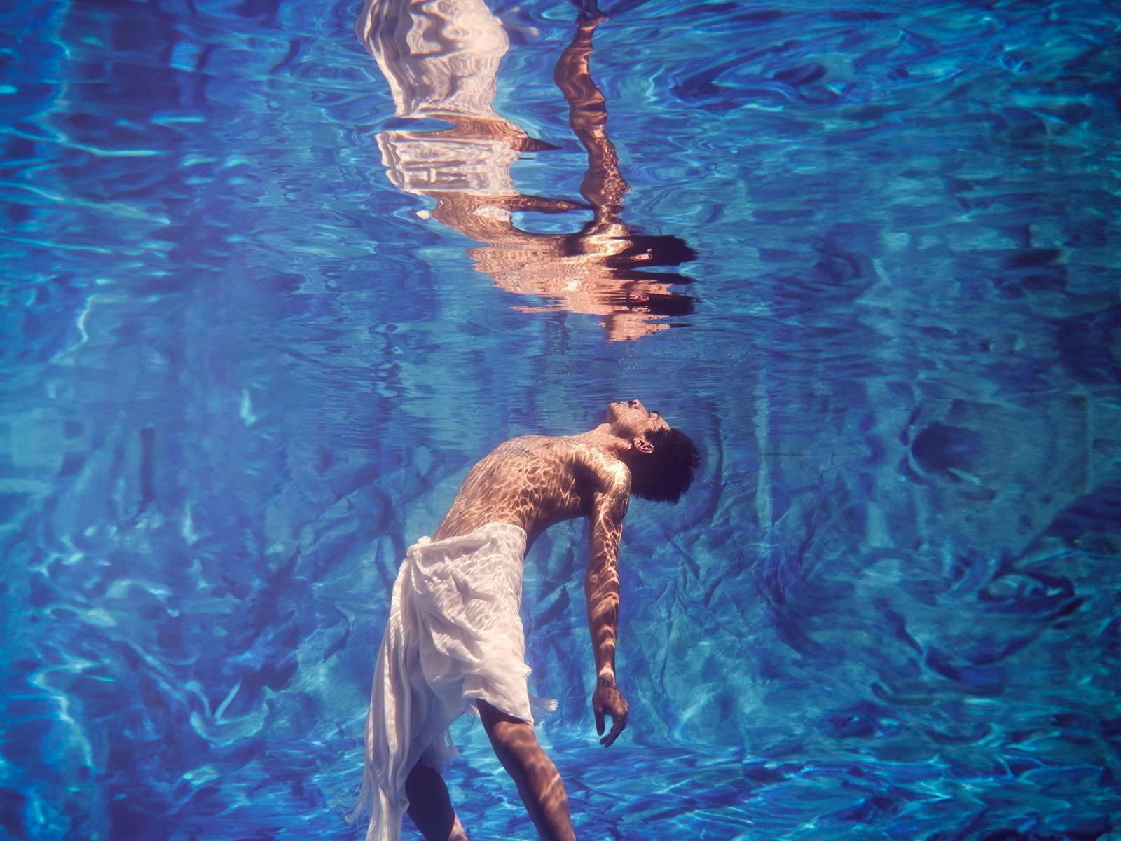 Person in pool showing reflection Person in pool showing reflection