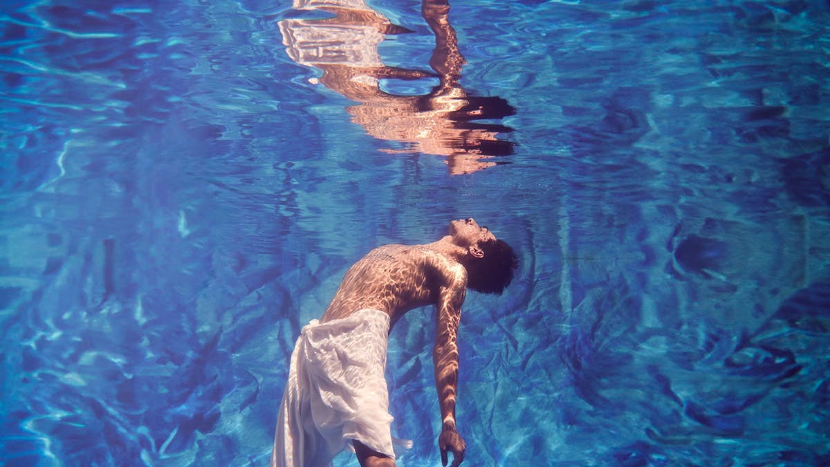 Person in pool showing reflection