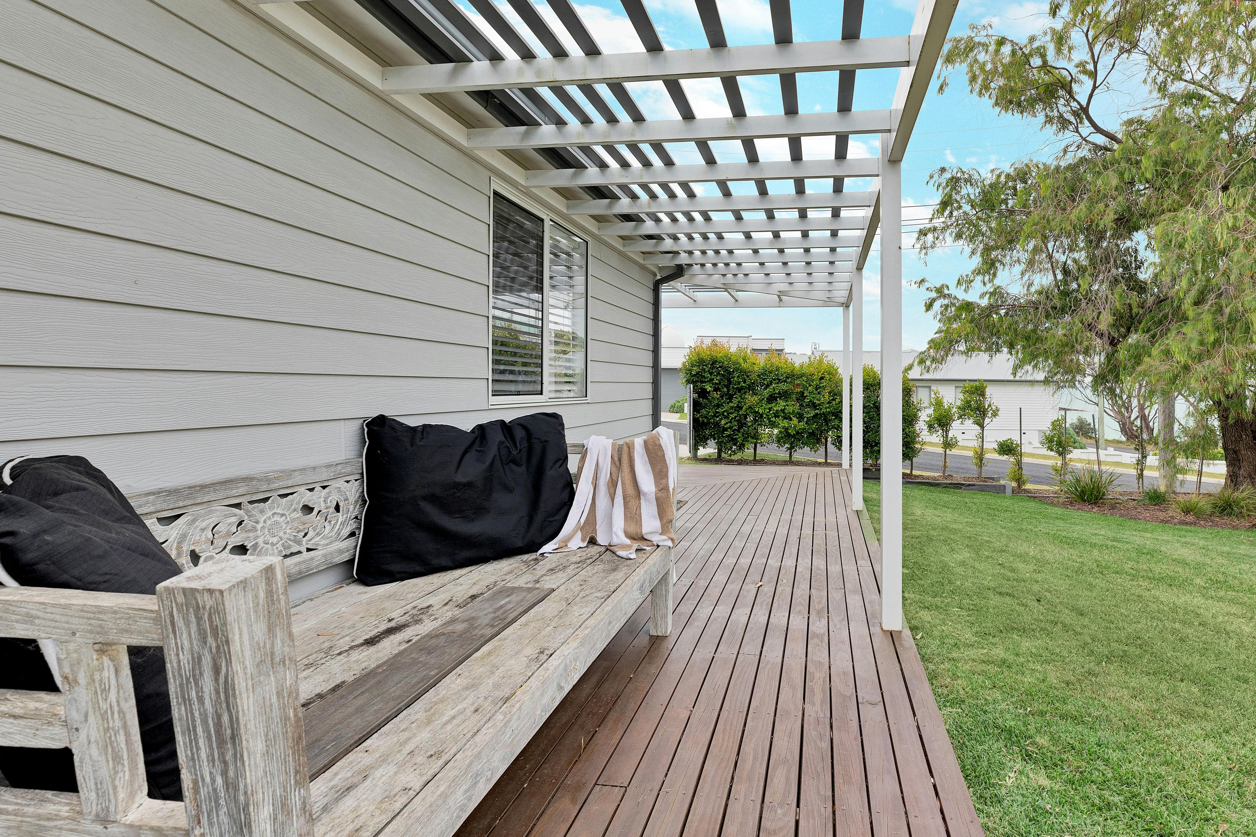 Deck with daybed and lush lawns