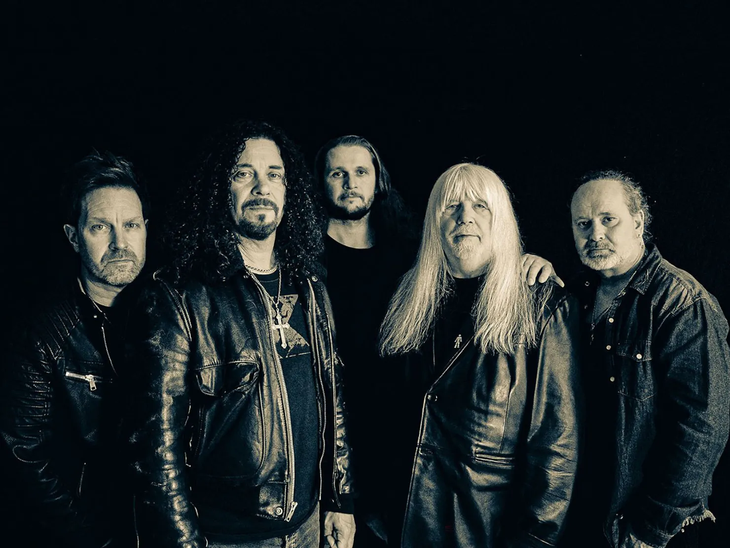 5 men with black background dressed in leather jackets