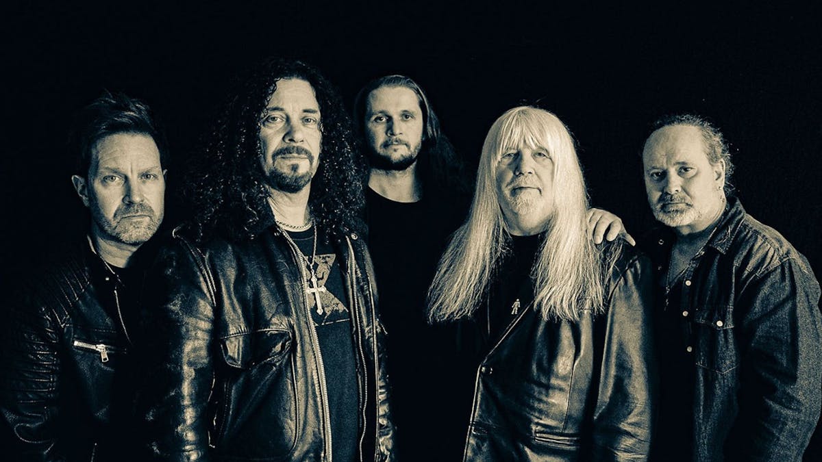 5 men with black background dressed in leather jackets