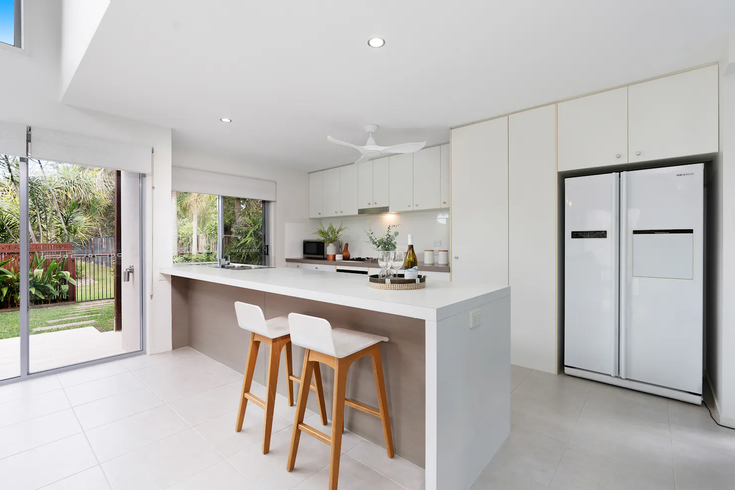 Open plan kitchen with views out to the tropical garden and pool