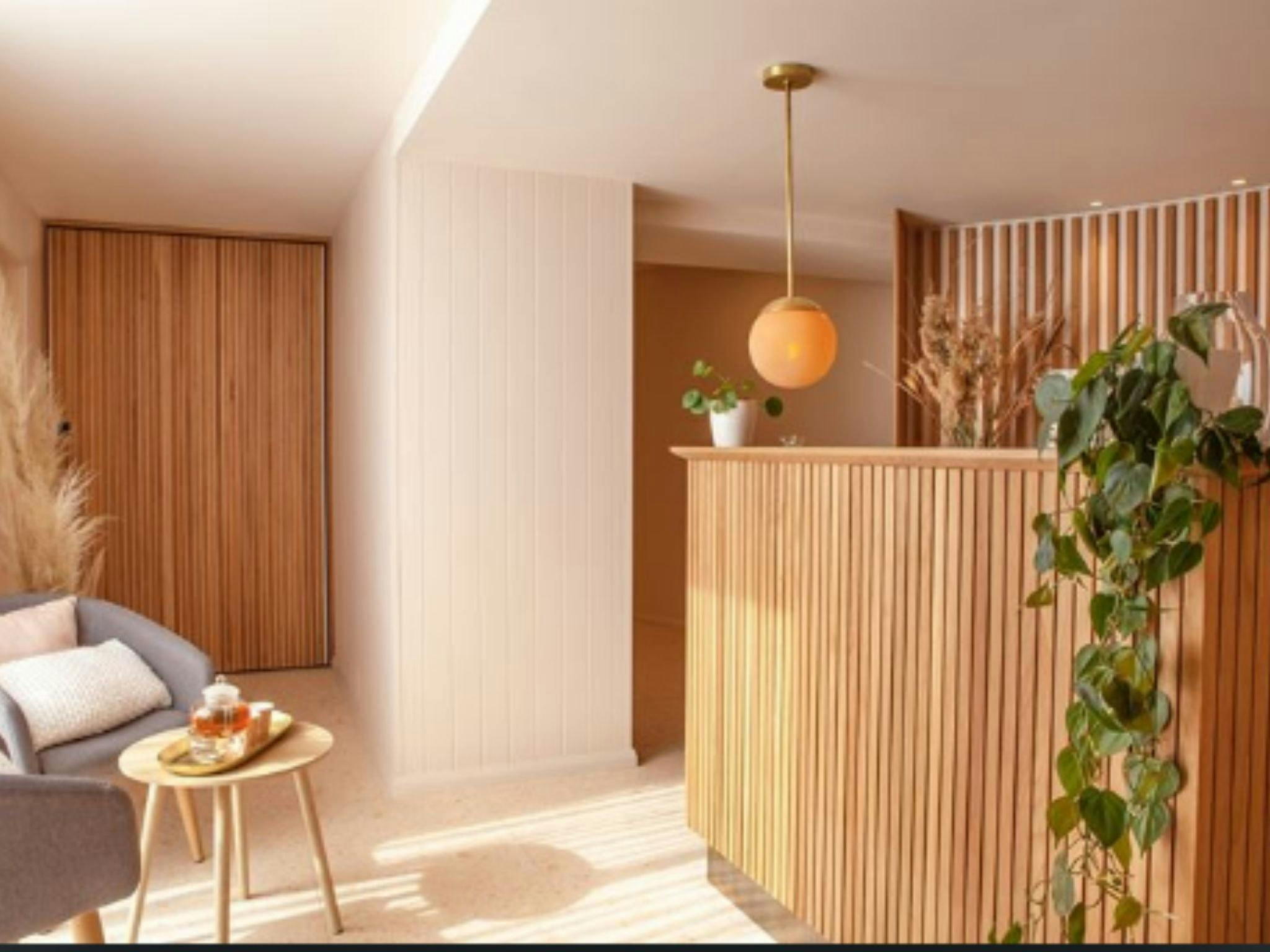 Interior shot of spa, with wooden welcome desk and seating area.