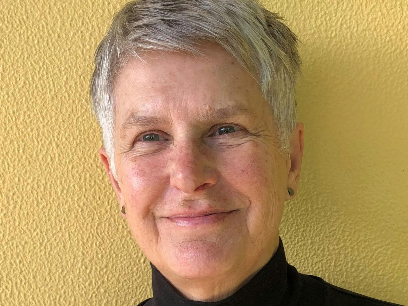 A portrait of a short haired woman and the cover of her book 'Max Dupain: A Portrait.'