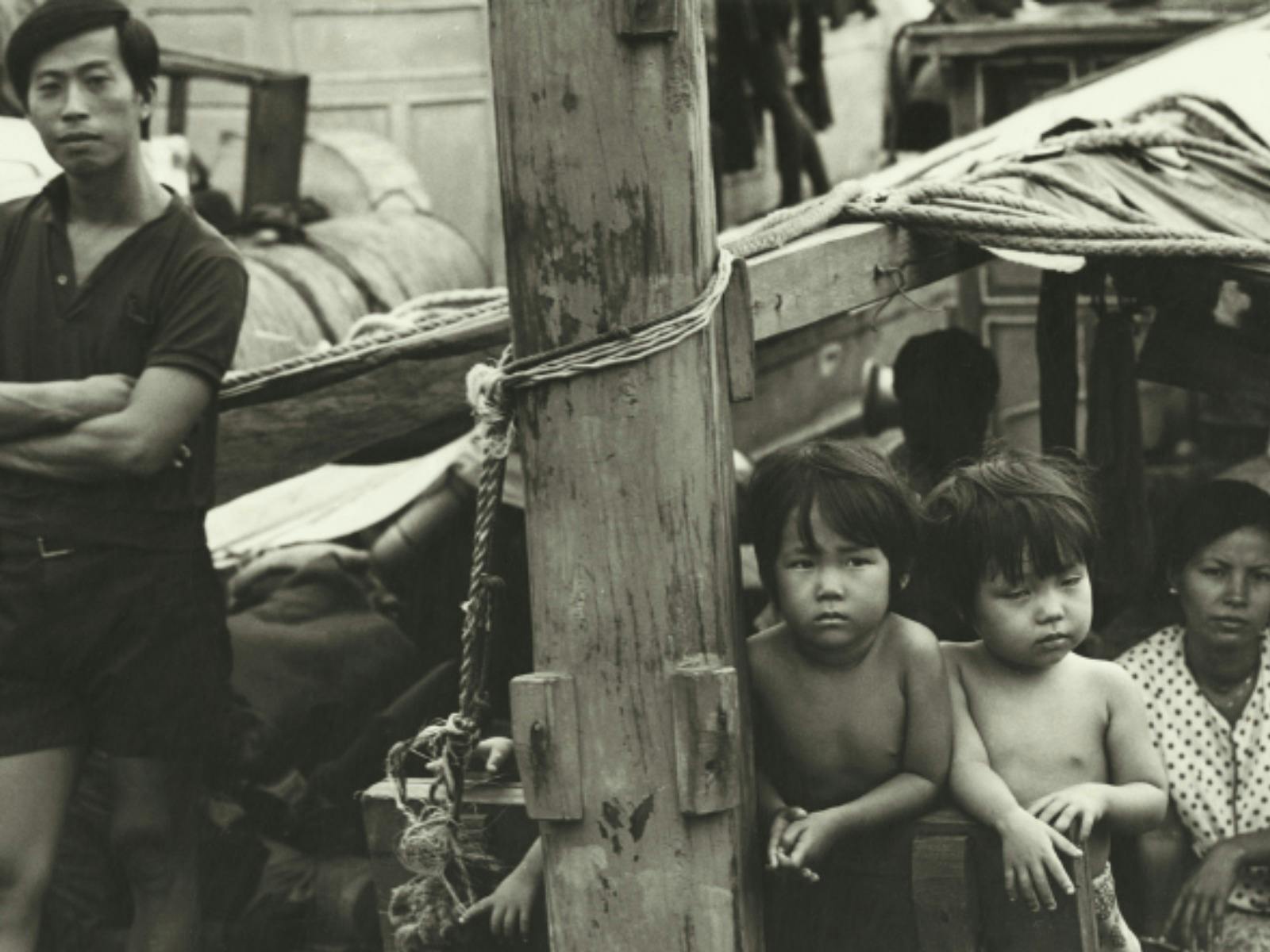 Photograph of the Lu family on the deck of TU DO in Darwin Harbour.