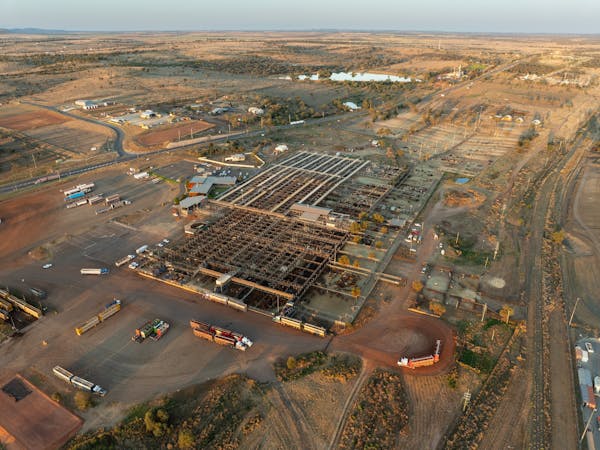 An aerial photo of the Roma Saleyards showing cattle yards and trucks An aerial photo of the Roma Saleyards showing cattle yards and trucks