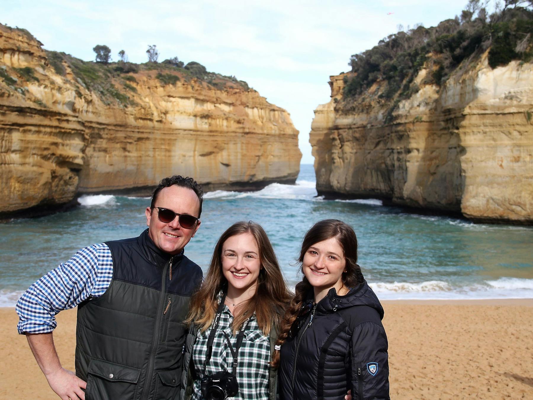 A family stands at Loch Ard Gorge, Great Ocean Road
