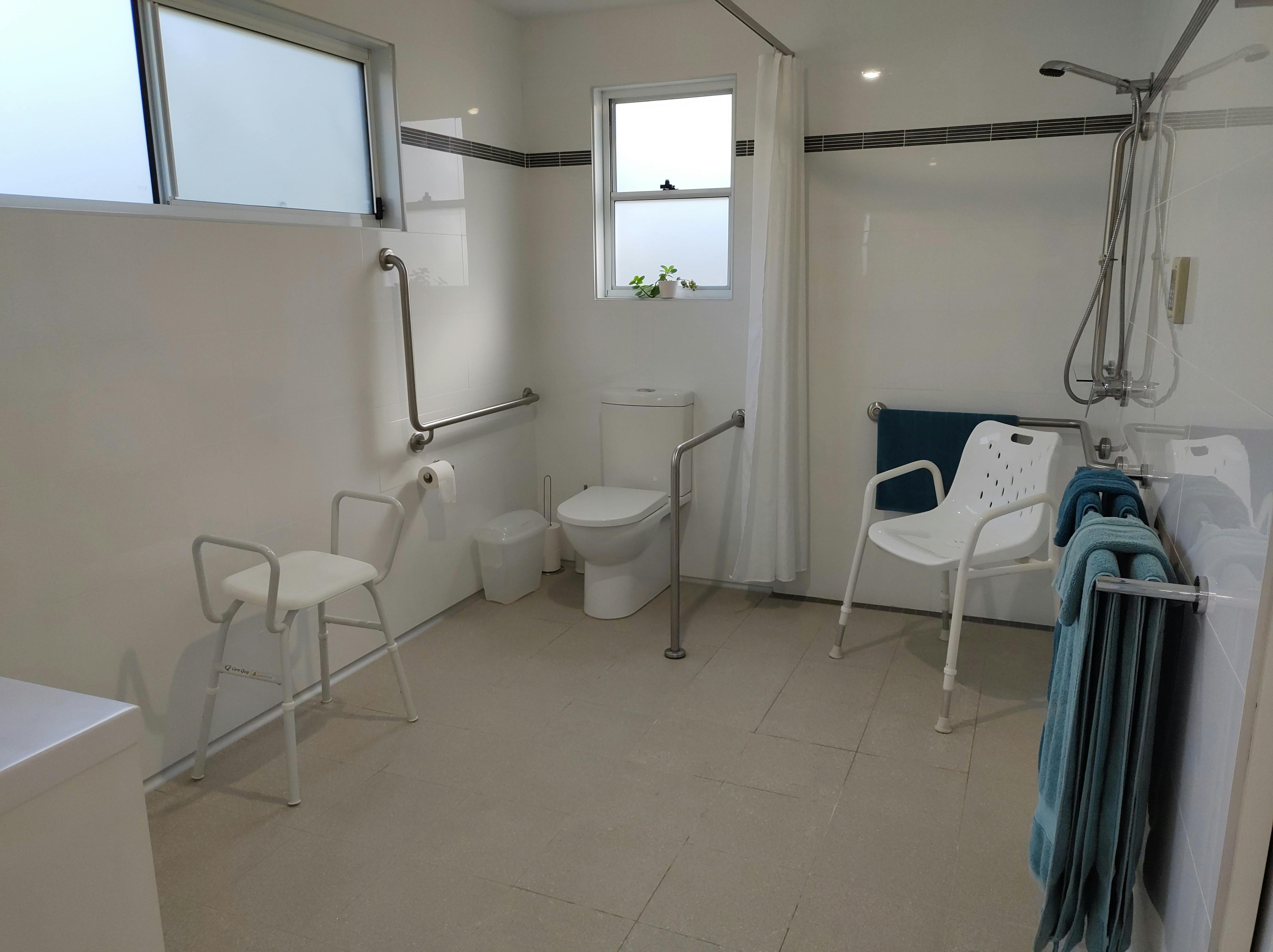 Large open plan bathroom with tep free shower, grab rails and glide under vanity