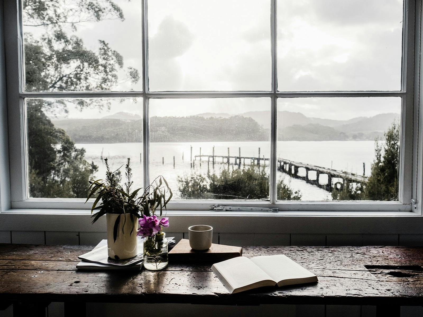 A picture frame window looking out onto the bay and jetty.