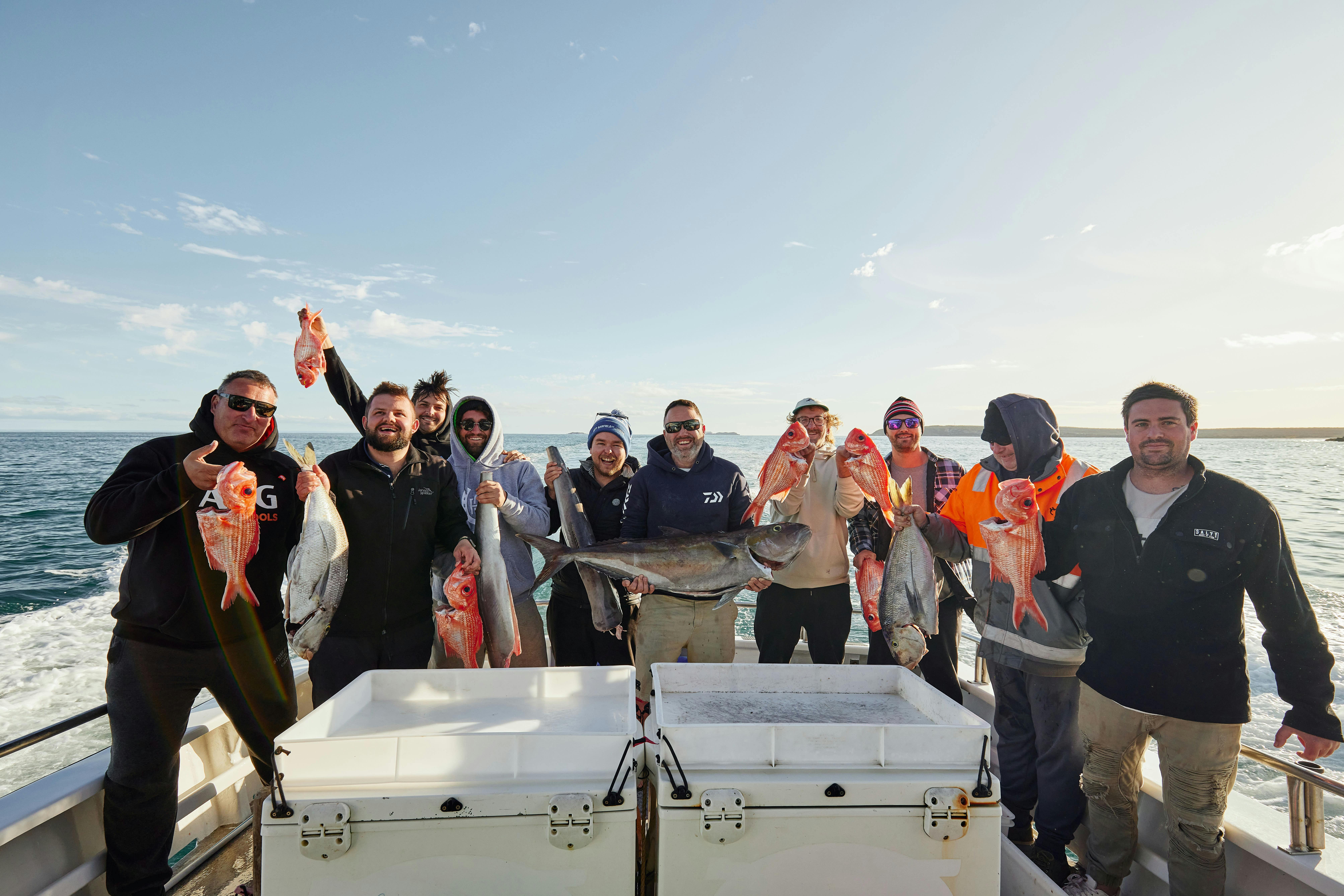 Happy crew onboard Reef Encounters showcasing their catch