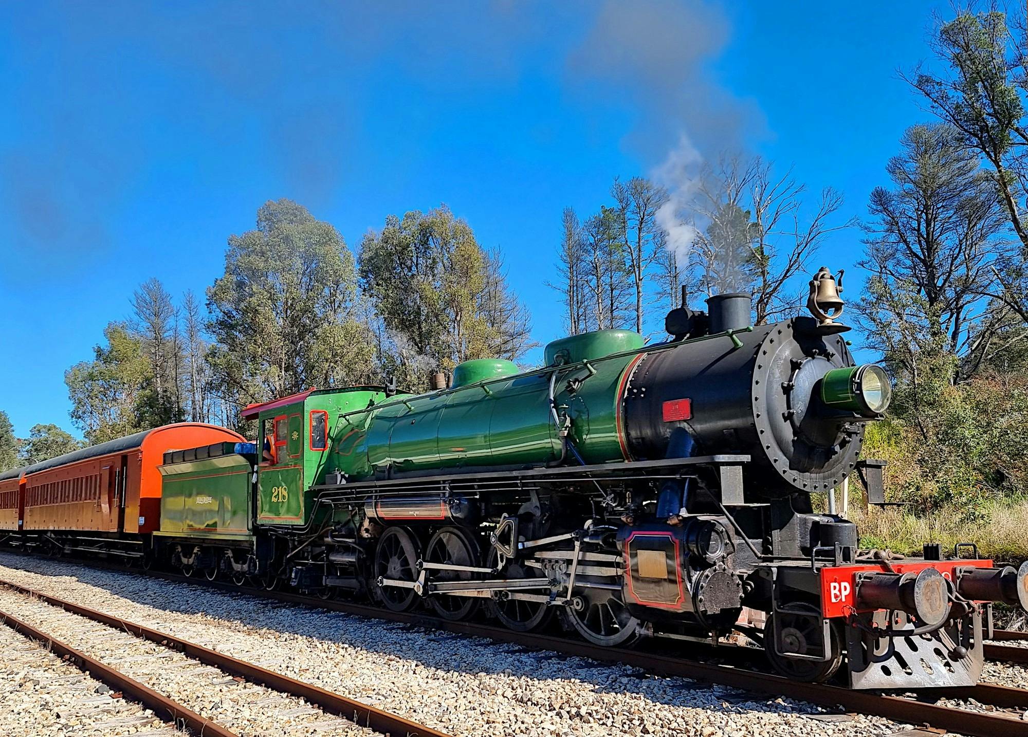 A Zig Zag Railway locotmotive in Green with carriages waits at Clarence NSW