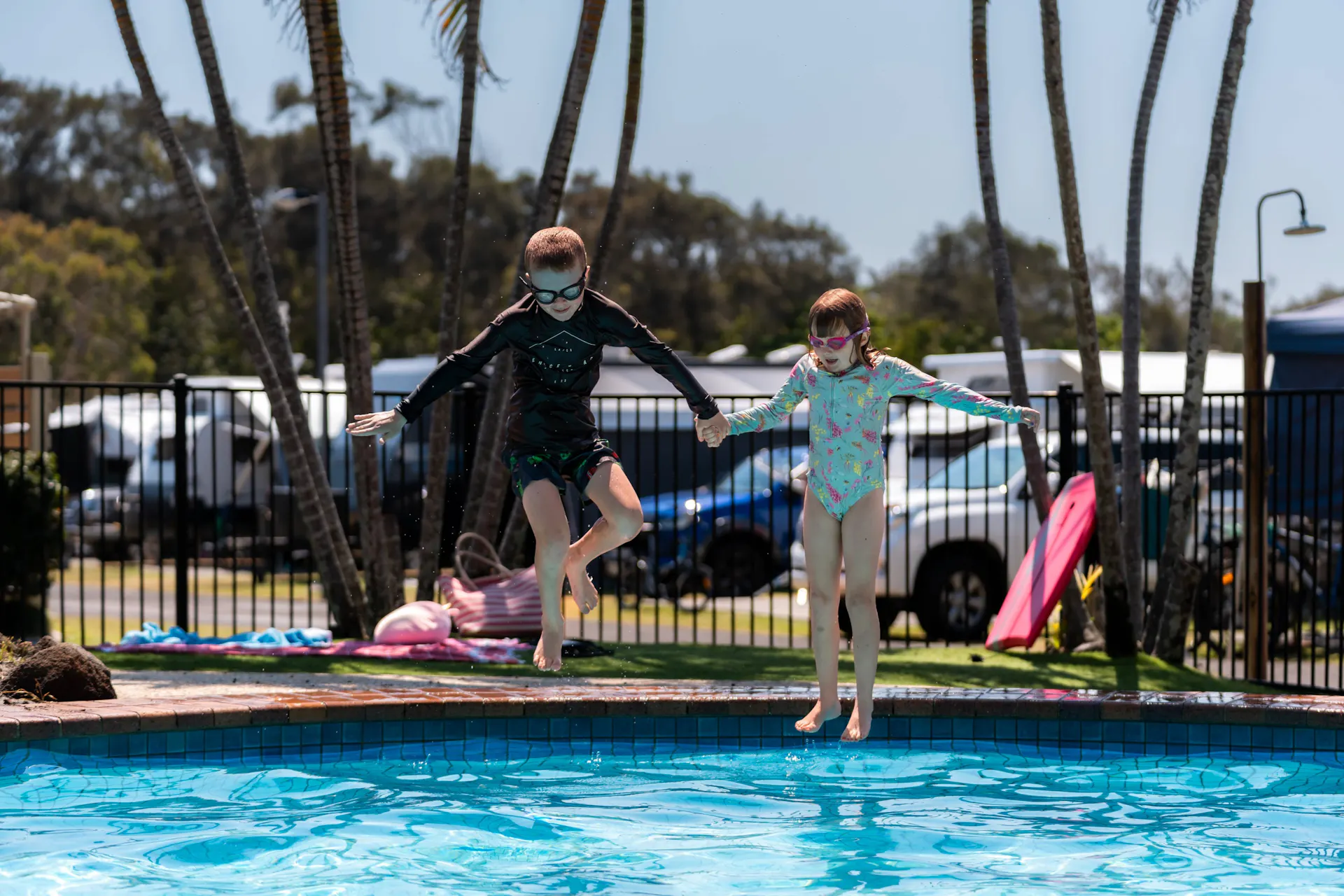 Shot of kids jumping into a pool at Dicky Beach Holiday Park