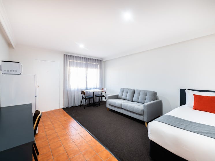 Spacious living area in River Motel's Family Suite, including extra single bed and sofa bed.