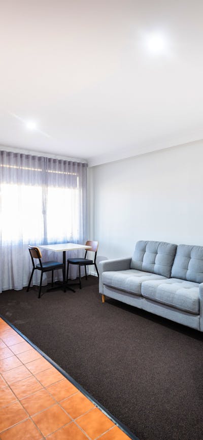 Spacious living area in River Motel's Family Suite, including extra single bed and sofa bed.