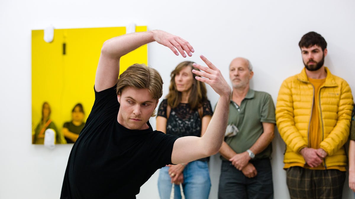Person with arms outstretched above their head dancing