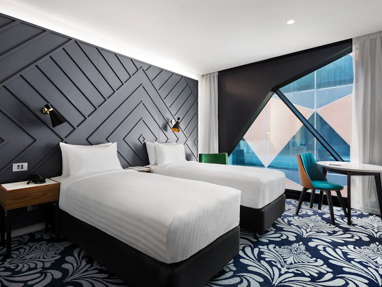 Twin Banksia Rooms enjoy light-industrial furnishings, 49-inch TV and capsule coffee machine.