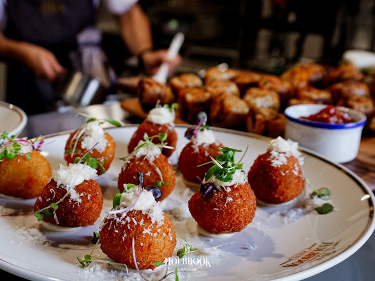 Arancini balls sitting on a white plate