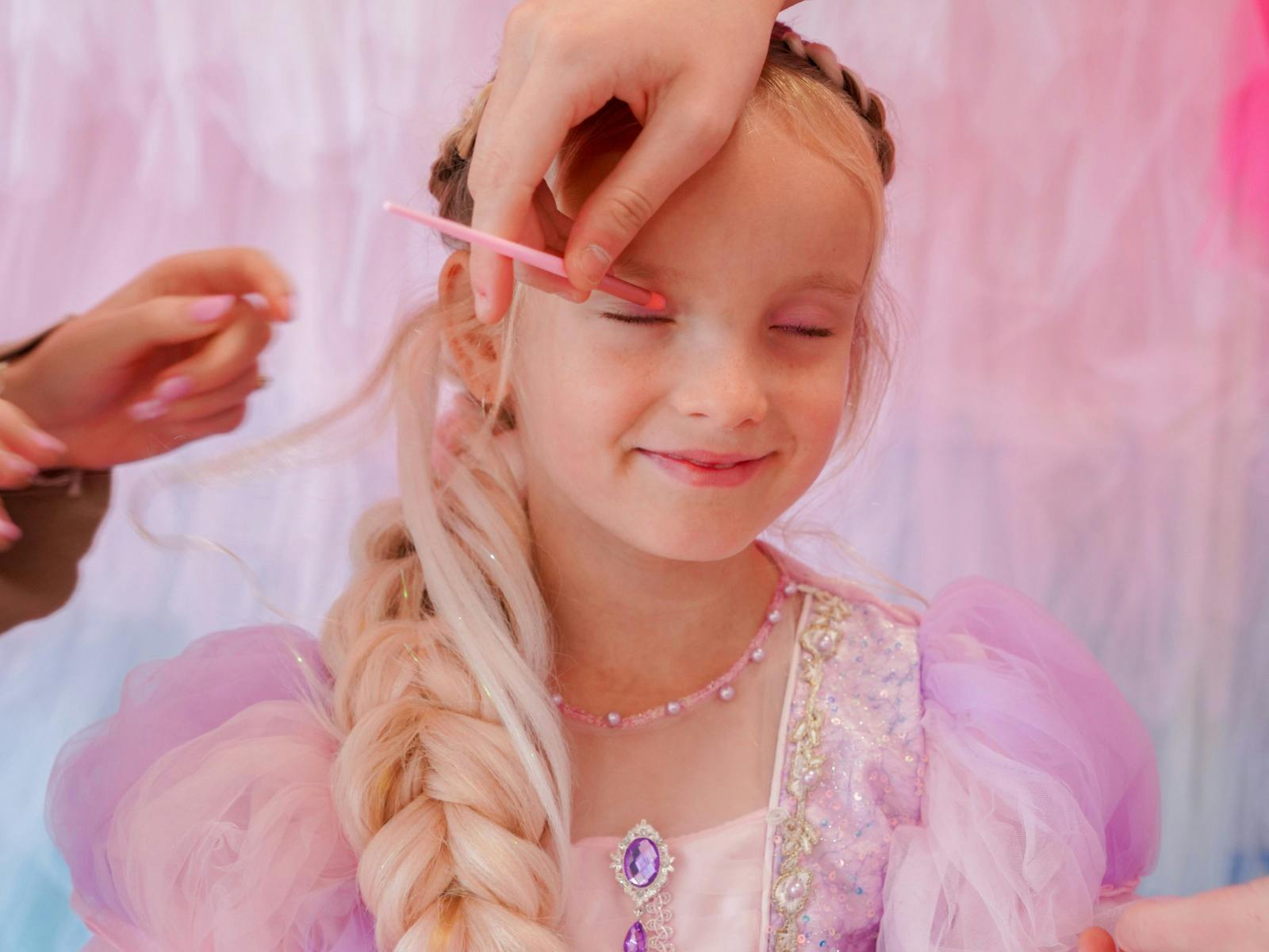 Girl getting hair and makeup done at party