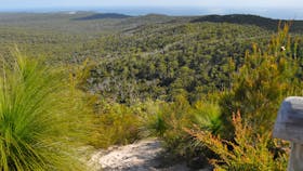 Landscape view from summit with sandy track in foreground.